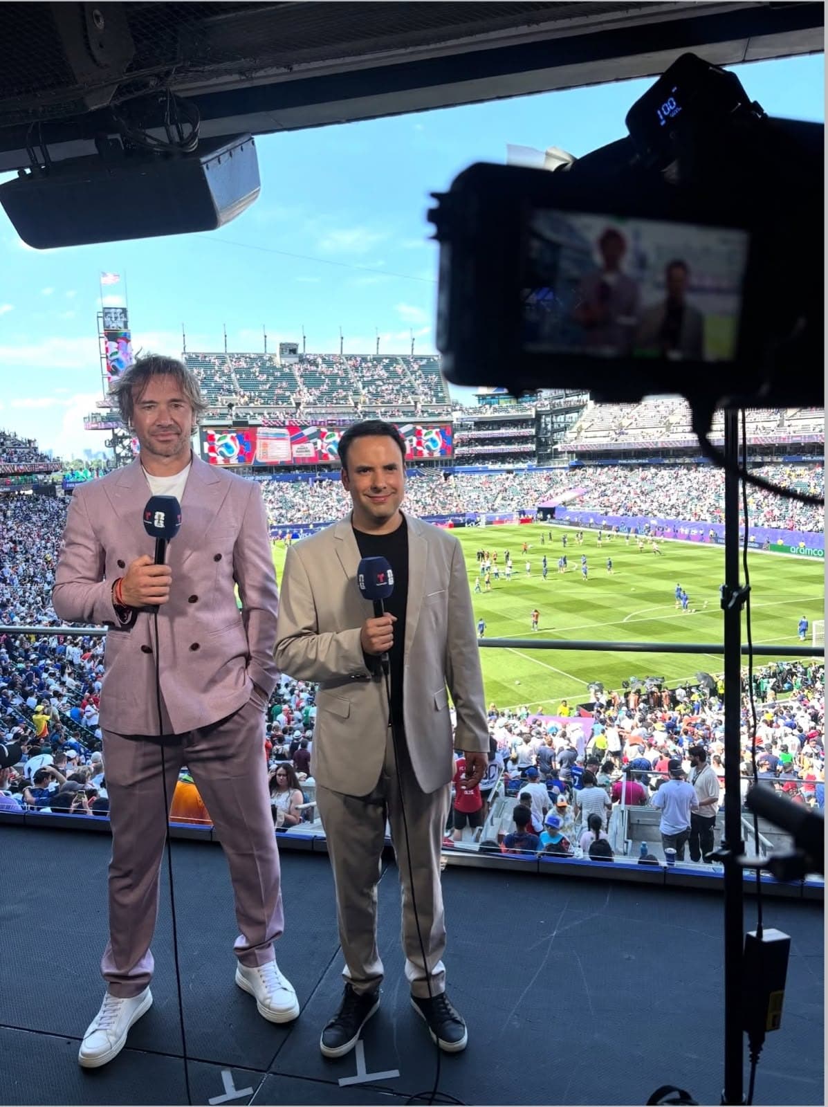 Diego Lugano y un periodista de Telemundo frente a la cámara, con el estadio lleno de fondo.